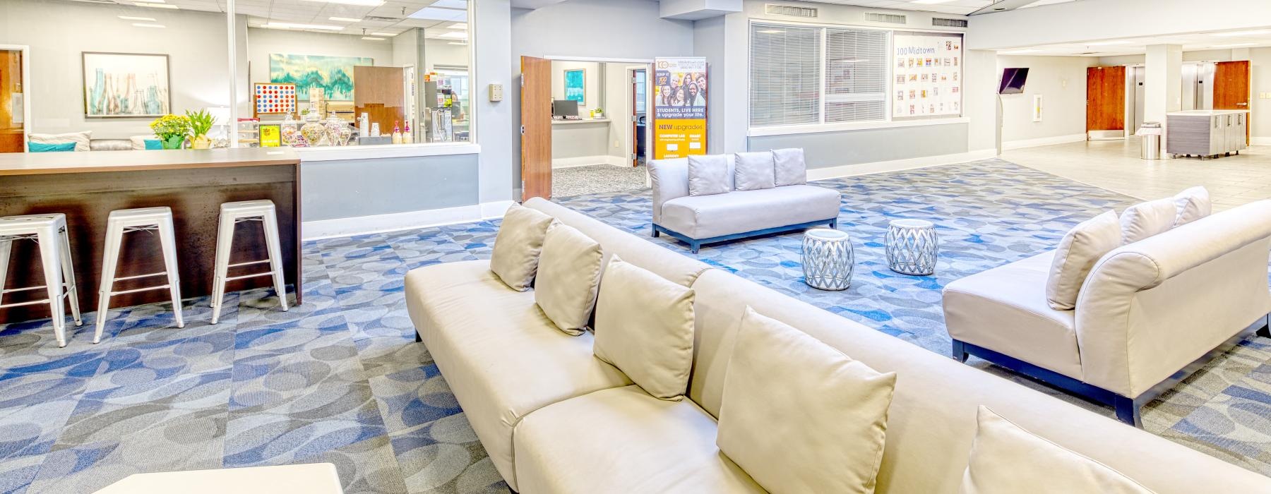 a room with white couches and a table