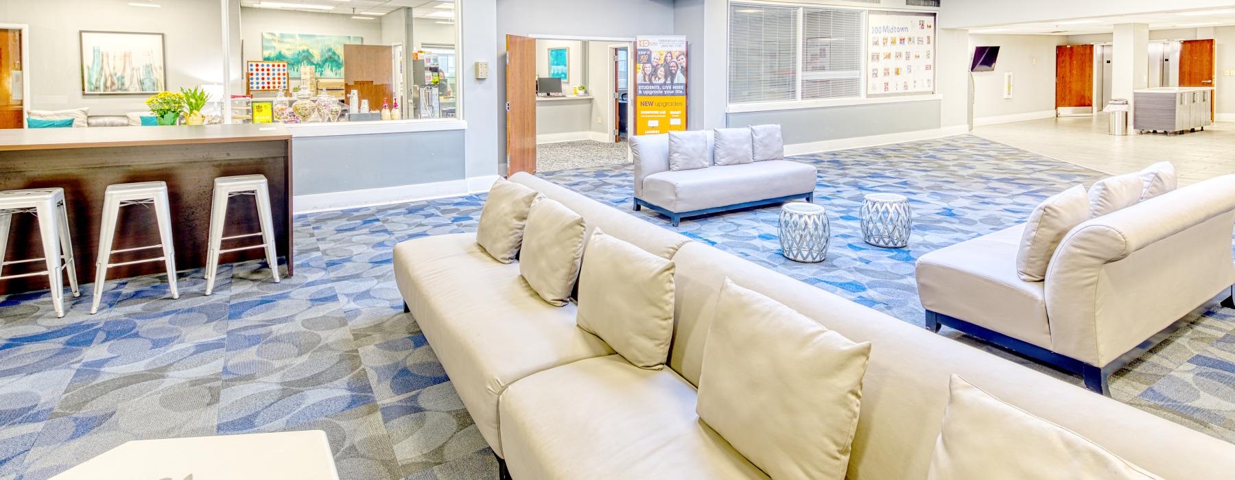 a room with white couches and a table